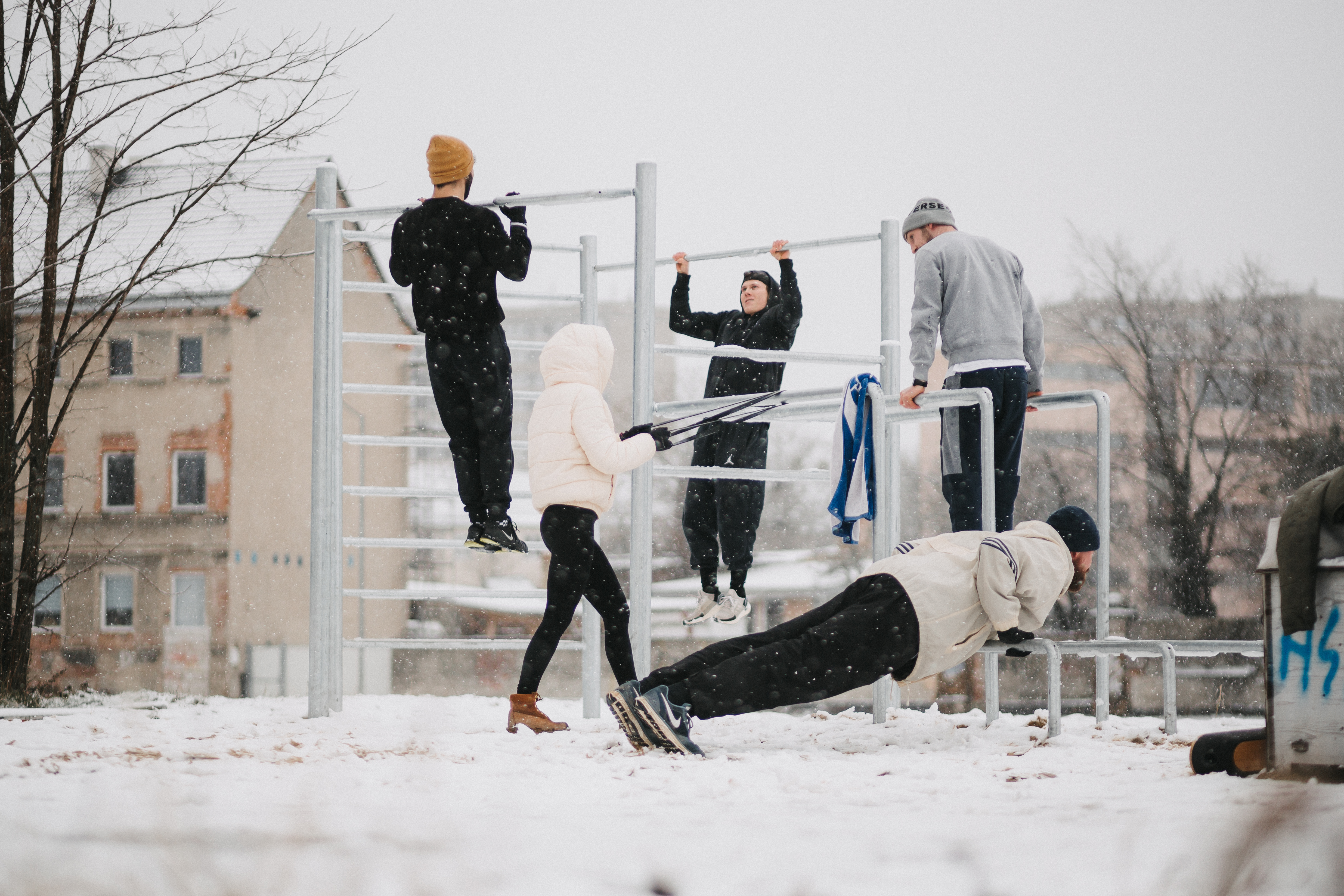 Outdoor calisthenics training in winter snow on a BARbara park